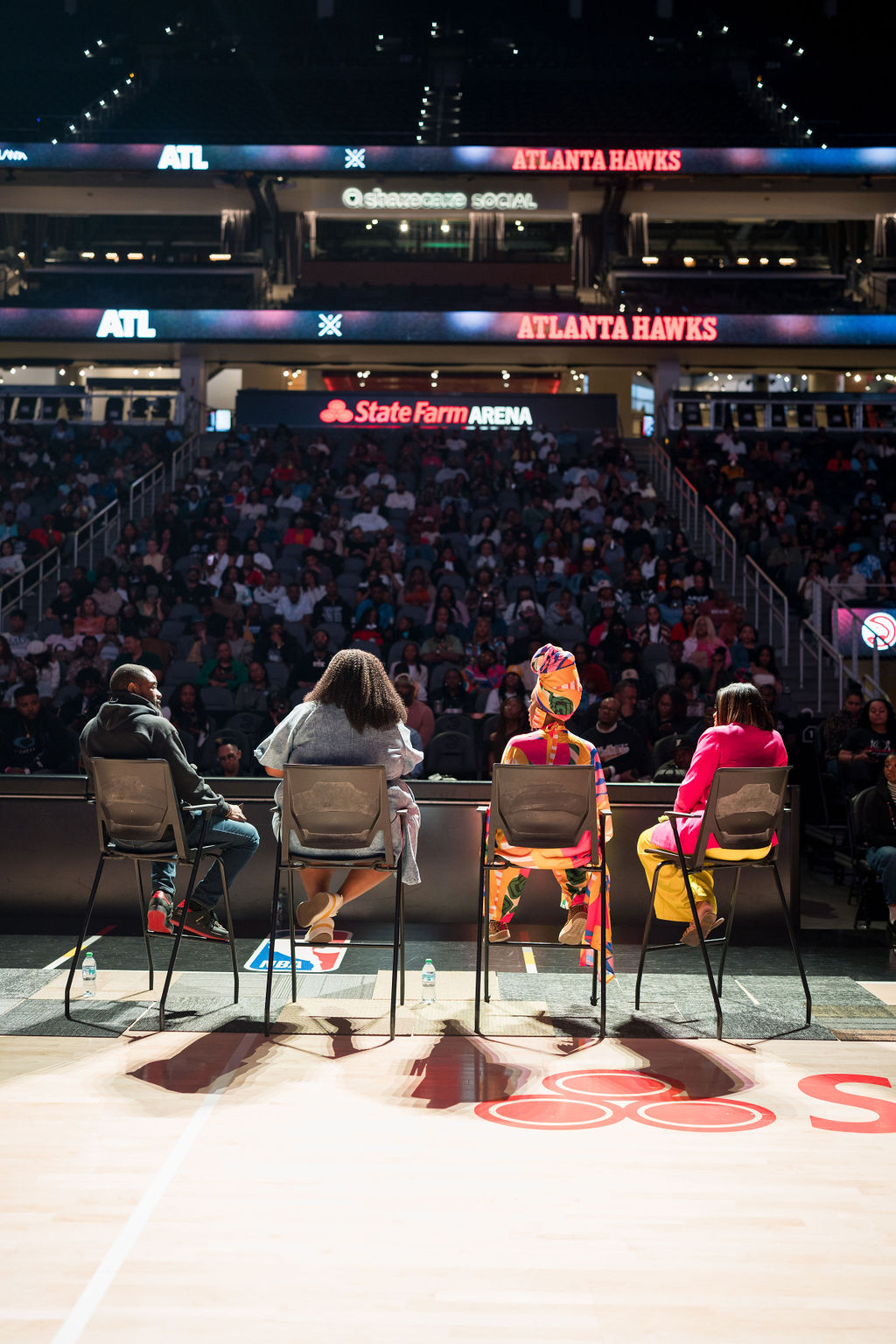 Panelists facing the crowd at State Farm Arena